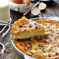 Slice of Hash Brown Crust Quiche Lorraine being lifted out a pie dish.