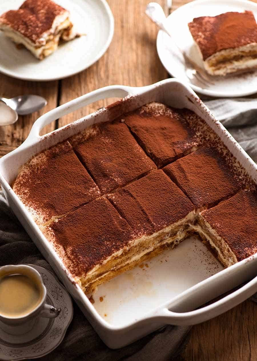 Tiramisu in a white dish being served for afternoon tea
