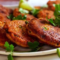 Close up of golden Thai Fish Cakes on a plate