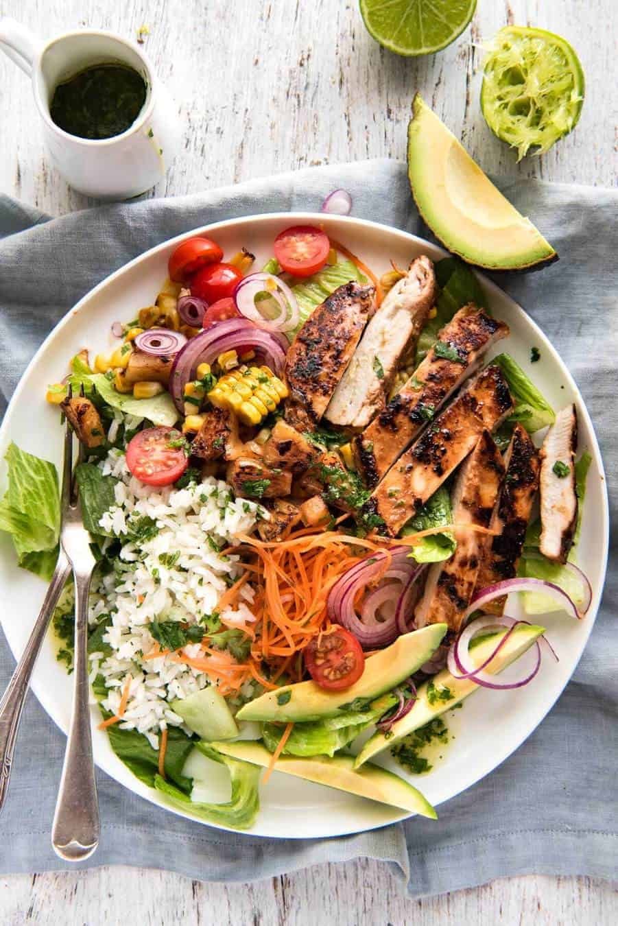A salad with chicken marinated in pineapple juice, coconut milk & spices and a beautiful cilantro (coriander) lime dressing. The flavours of Hawaii - in a salad! www.recipetineats.com