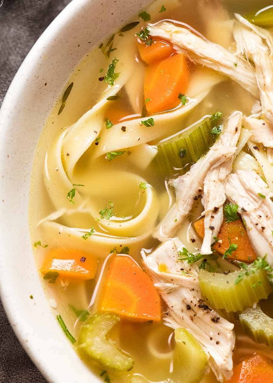 Close ups of clear chicken soup broth for Homemade Chicken Noodle Soup