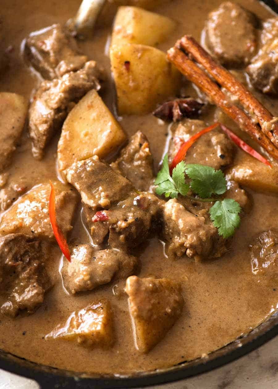 Close up of Massaman Curry in a black skillet, fresh off the stove
