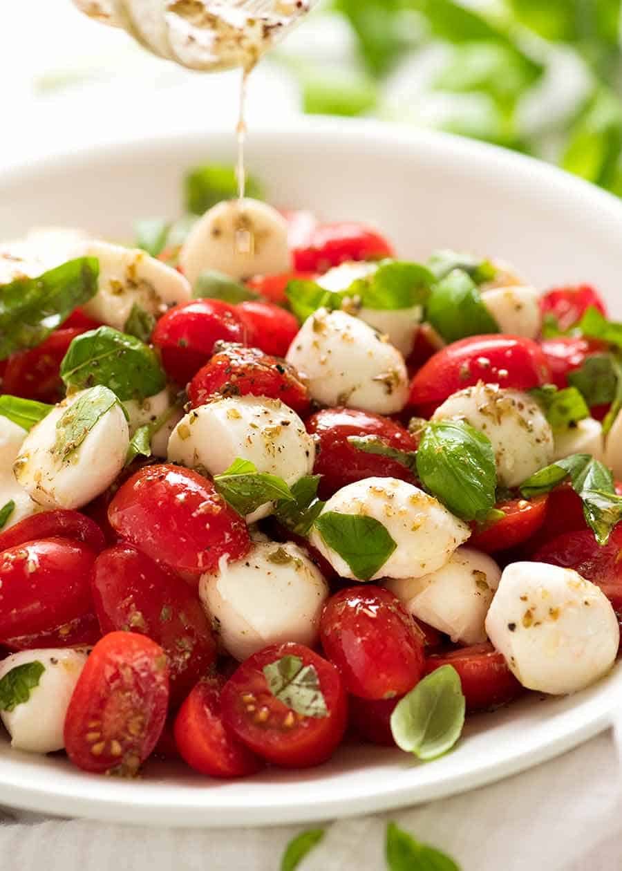 The first dressing for a Caprese Salads isa a garlic herb vinaigrette, It's finished with balsamic glaze just before serving.